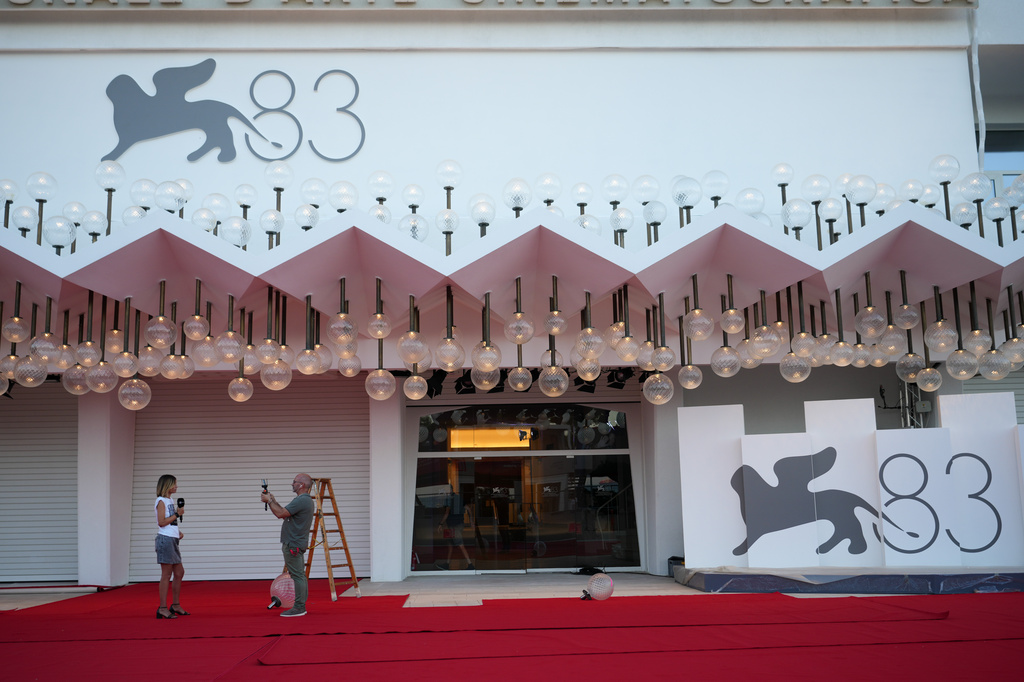 A presenter is filmed on the red carpet prior to the 83rd edition of the Venice Film Festival in Venice, Italy, on Monday, Aug. 31, 2026. (Photo by Alessandra Tarantino/Invision/AP)