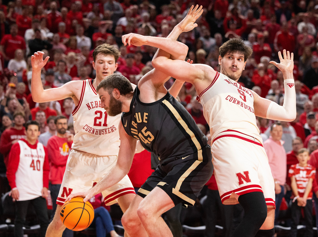 Purdue's Oscar Cluff (45) tangles with Nebraska's Berke Büyüktuncel (9) under the basket during the second half of an NCAA college basketball game, Tuesday, Feb. 10, 2026, in Lincoln, Neb. (AP Photo/Rebecca S. Gratz)