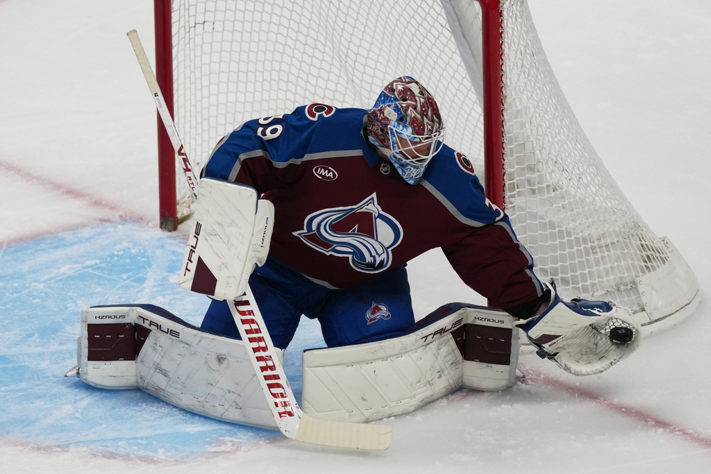 Colorado Avalanche goaltender MacKenzie Blackwood makes a glove-save in the first period of an NHL hockey game against the Detroit Red Wings, Monday, Feb. 2, 2026, in Denver. (AP Photo/David Zalubowski)