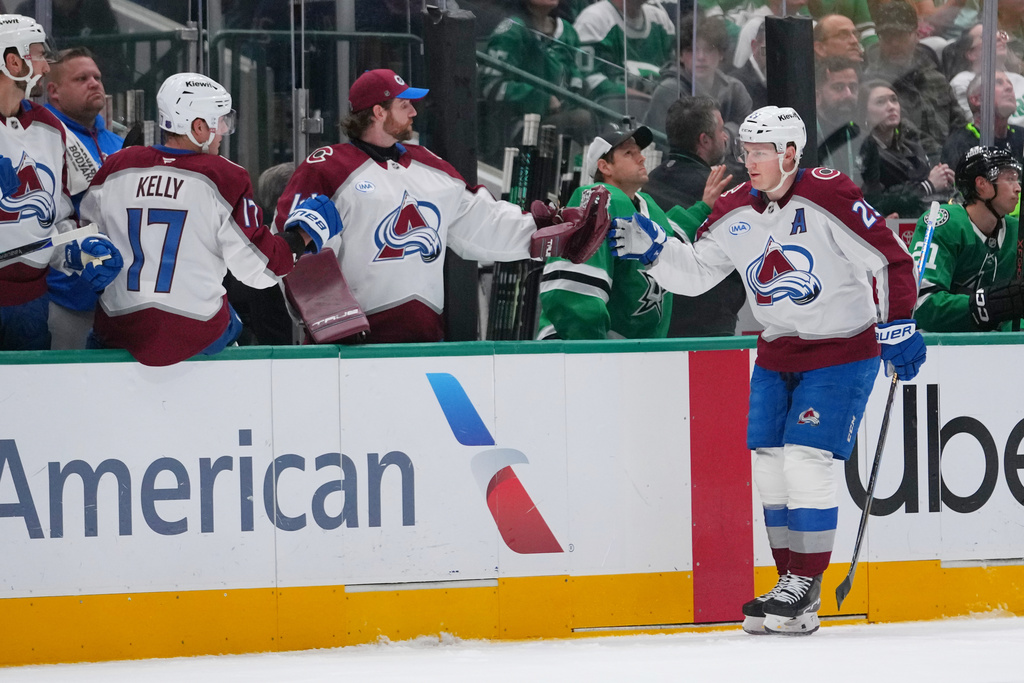 Colorado Avalanche center Nathan MacKinnon skates by his bench after scoring a goal against the Dallas Stars during the first period of an NHL hockey game Friday, March 6, 2026, in Dallas. (AP Photo/Julio Cortez)