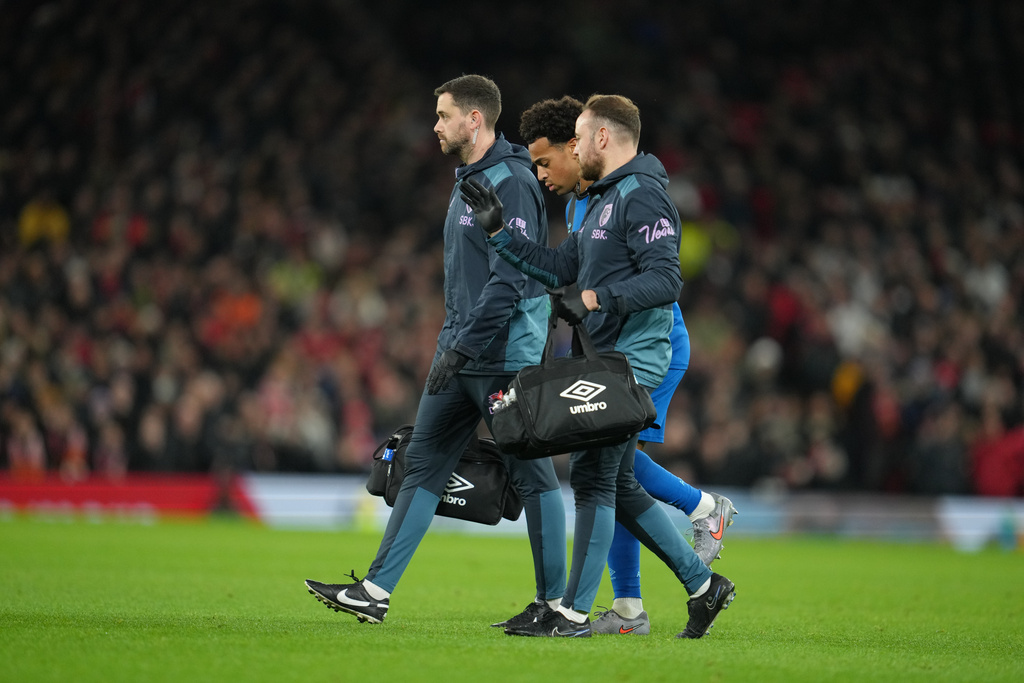 Bournemouth's Tyler Adams is helped off the pitch during a Premier League soccer match between Manchester United and Bournemouth in Manchester, England, Monday, Dec. 15, 2025. (AP Photo/Jon Super)