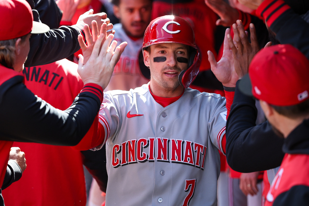 Cincinnati Reds' Spencer Steer celebrates after scoring on an RBI double hit by TJ Friedl during the ninth inning of baseball game against the Minnesota Twins, Sunday, April 19, 2026, in Minneapolis. (AP Photo/Matt Krohn)