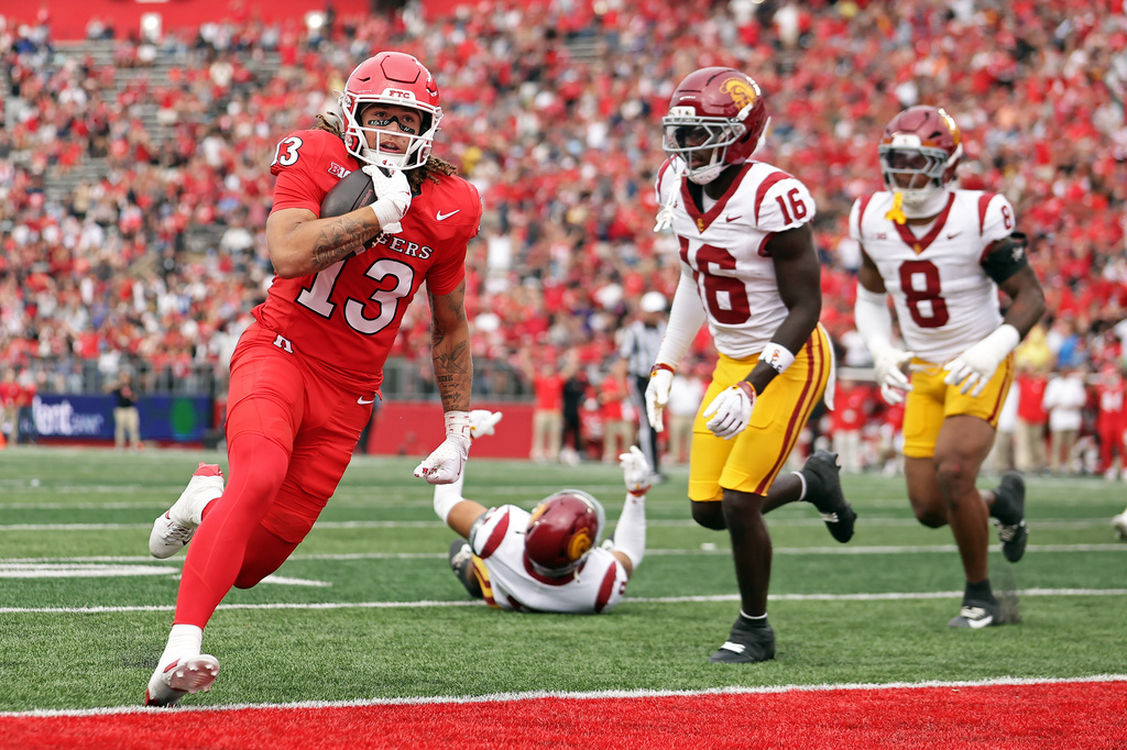 Rutgers wide receiver Elias Coke (13) scores a touchdown past Southern California cornerback Prophet Brown (16) during the first half of an NCAA college football game Saturday, Sept. 19, 2026, in Piscataway, N.J. (AP Photo/Adam Hunger)