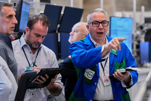 Options traders Joseph Arrigo, right, works on the floor of the New York Stock Exchange, Monday, Oct. 20, 2025. (AP Photo/Richard Drew) Options traders Joseph Arrigo, right, works on the floor of the New York Stock Exchange, Monday, Oct. 20, 2025. (AP Photo/Richard Drew)
