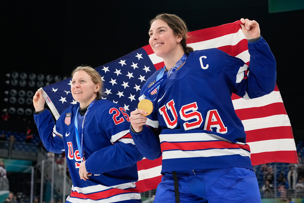 United States' Kendall Coyne, left, and United States' Hilary Knight celebrate after victory ceremony for women's ice hockey at the 2026 Winter Olympics, in Milan, Italy, Thursday, Feb. 19, 2026. (AP Photo/Hassan Ammar)