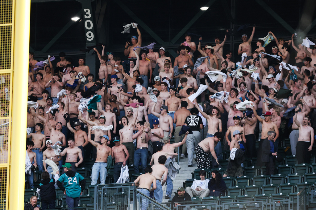 Fans go "tarps off"in the sixth inning of a baseball game between the Seattle Mariners and Chicago White Sox, Tuesday, May 19, 2026, in Seattle. (AP Photo/Kevin Ng)