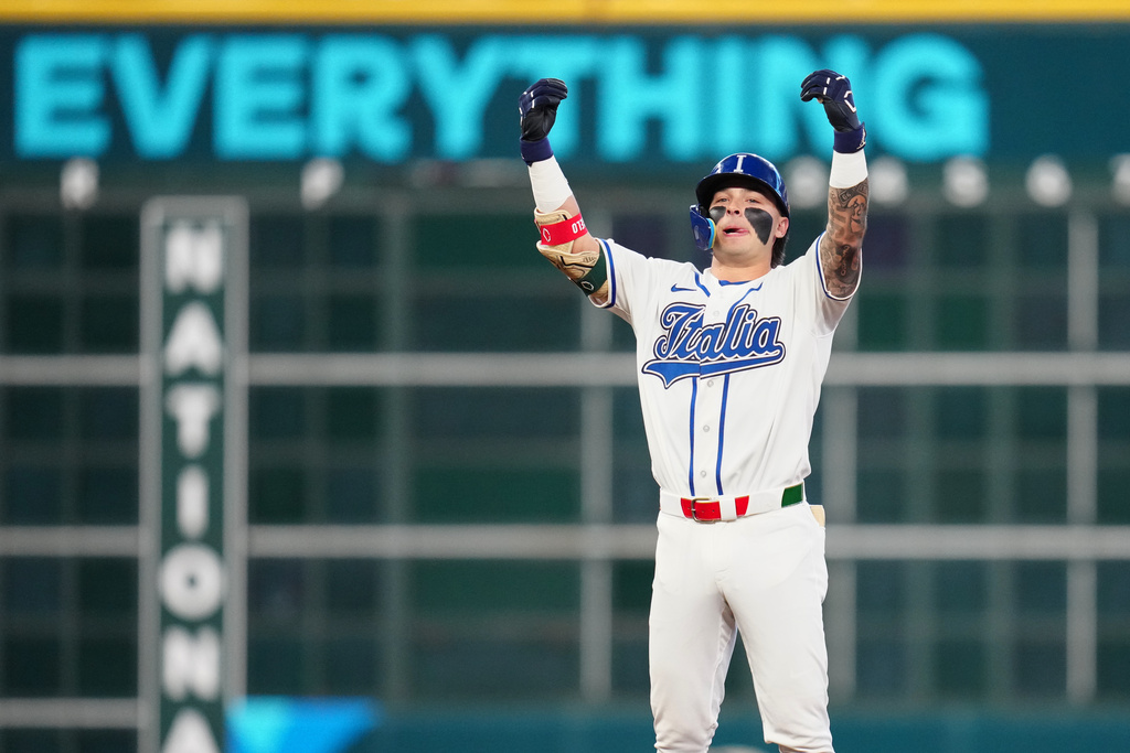 Italy's Andrew Fischer celebrates after hitting a two-run double during the fourth inning of a World Baseball Classic quarterfinal game against Puerto Rico, Saturday, March 14, 2026, in Houston. (AP Photo/Karen Warren)
