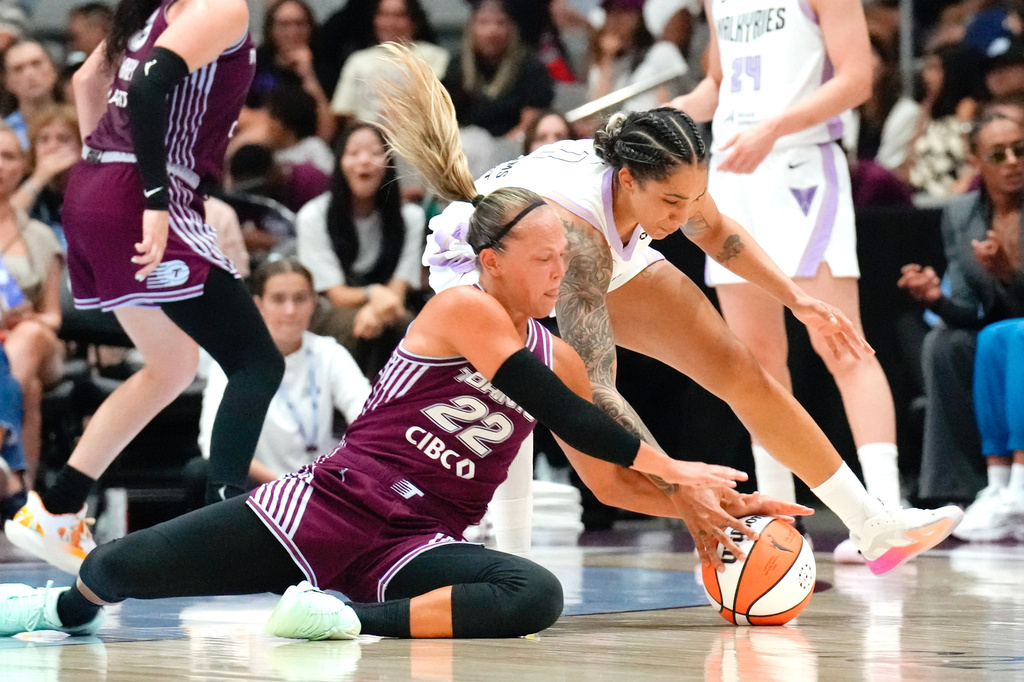 Toronto Tempo Julie Allemand (22) battles for a loose ball with Golden State Valkyries Gabby Williams during the first half of a WNBA basketball game in Toronto on Wednesday, July 8, 2026. (Chris Young/The Canadian Press via AP)