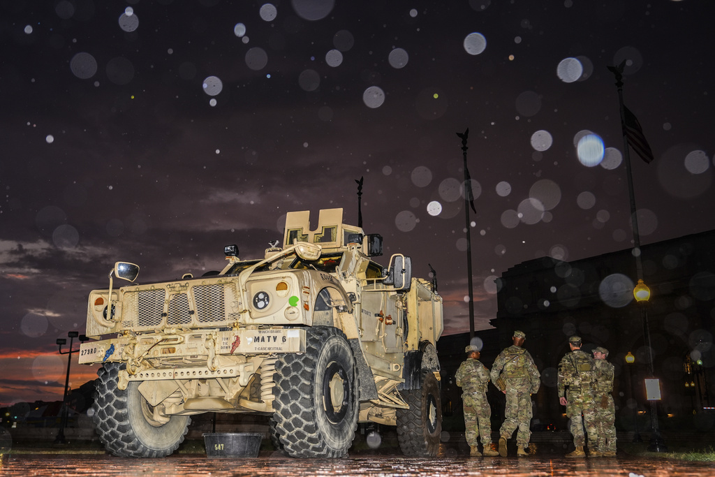 Members of the District of Columbia National Guard stand next to their M-ATV outside Union Station, Sunday, Aug. 17, 2025, in Washington. (AP Photo/Julia Demaree Nikhinson)