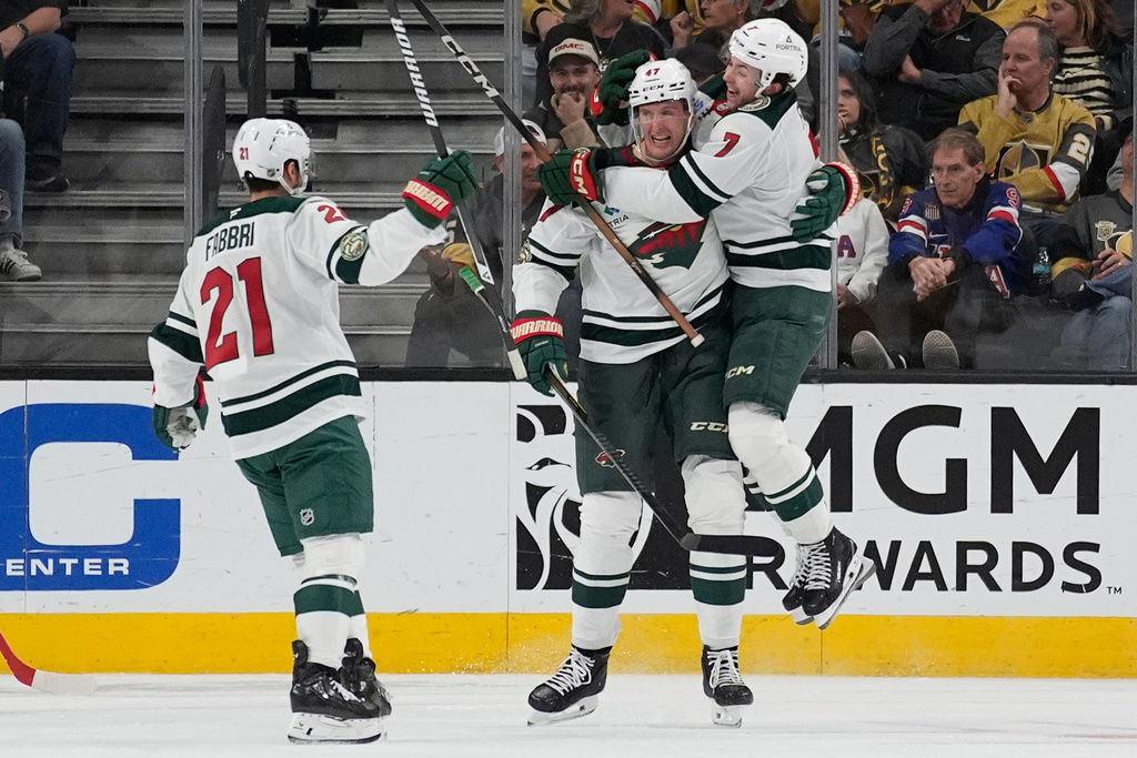 Minnesota Wild defenseman Brock Faber (7) celebrates withe Minnesota Wild center Michael McCarron (47) after McCarron scored against the Vegas Golden Knights during the second period of an NHL hockey game Friday, March 6, 2026, in Las Vegas. (AP Photo/John Locher)