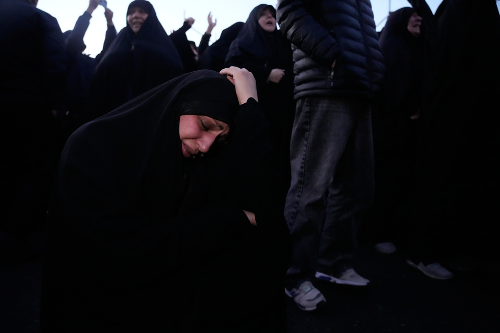 A government supporter mourns in a gathering after state TV officially announced the death of Iranian Supreme Leader Ayatollah Ali Khamenei, in Tehran, Iran, Sunday, March 1, 2026. (AP Photo/Vahid Salemi)