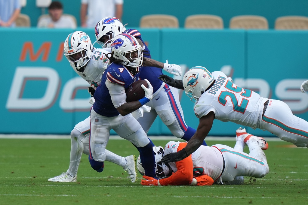 Buffalo Bills' James Cook (4) runs during the second half of an NFL football game against the Miami Dolphins, Sunday, Nov. 9, 2025, in Miami Gardens, Fla. (AP Photo/Lynne Sladky)
