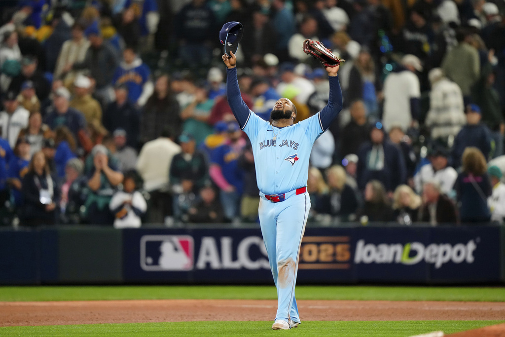 Toronto Blue Jays' Vladimir Guerrero Jr. (27) celebrates after the final out to defeat the Seattle Mariners in Game 3 of baseball's American League Championship Series, Wednesday, Oct. 15, 2025, in Seattle. (Frank Gunn/The Canadian Press via AP)