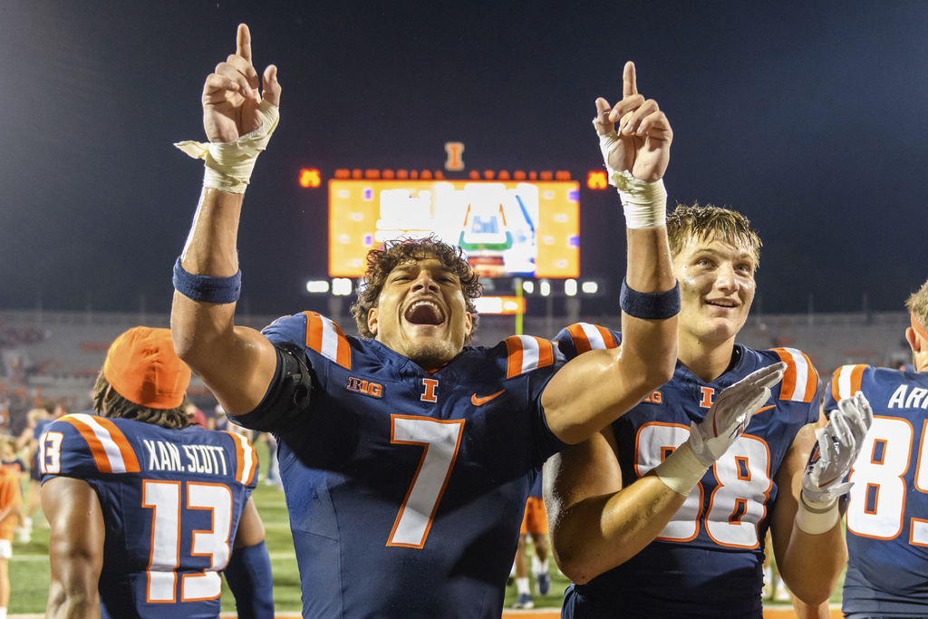 Illinois defensive back Matthew Bailey (7) and Davin Stoffel celebrate a win following an NCAA college football game against Western Michigan Saturday, Sept. 13, 2025, in Champaign, Ill. (AP Photo/Craig Pessman)