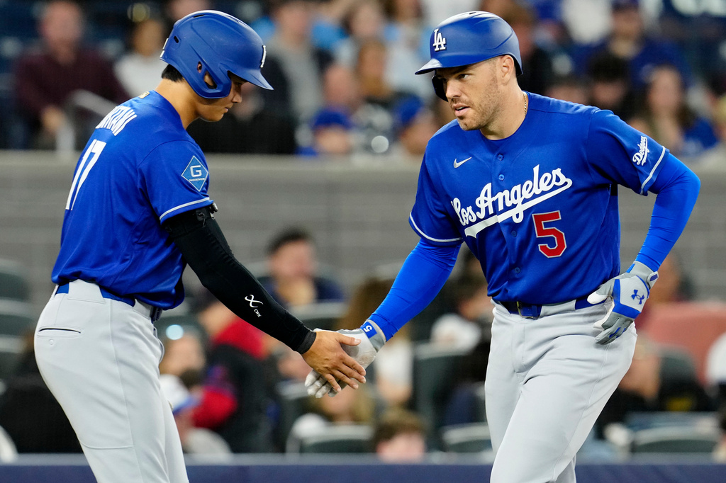 Los Angeles Dodgers' Shohei Ohtani (17) congratulates teammate Freddie Freeman (5) who comes in to score on his two-run home run against the Toronto Blue Jays during third-inning baseball game action in Toronto, Monday, April 6, 2026. (Frank Gunn/The Canadian Press via AP)