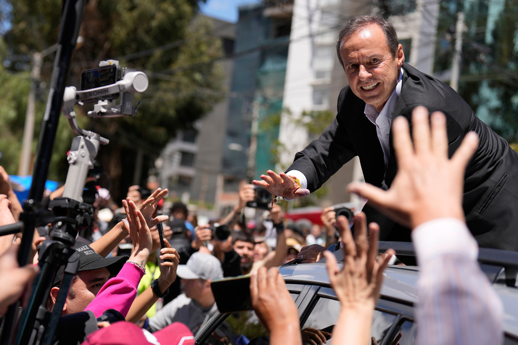 Presidential candidate Jorge "Tuto" Quiroga greets supporters after voting in a presidential runoff election in La Paz, Bolivia, Sunday, Oct. 19, 2025. (AP Photo/Natacha Pisarenko)