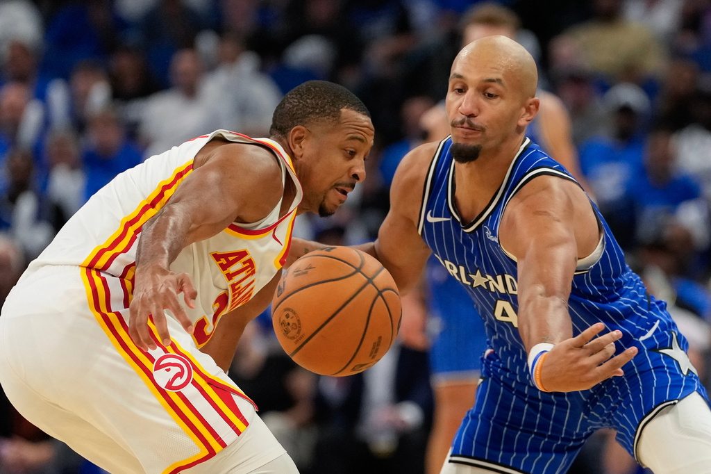Atlanta Hawks guard CJ McCollum, left, loses control of the ball against Orlando Magic guard Jalen Suggs (4) during the second half of an NBA basketball game, Wednesday, Oct. 21, 2026, in Orlando, Fla. (AP Photo/John Raoux)