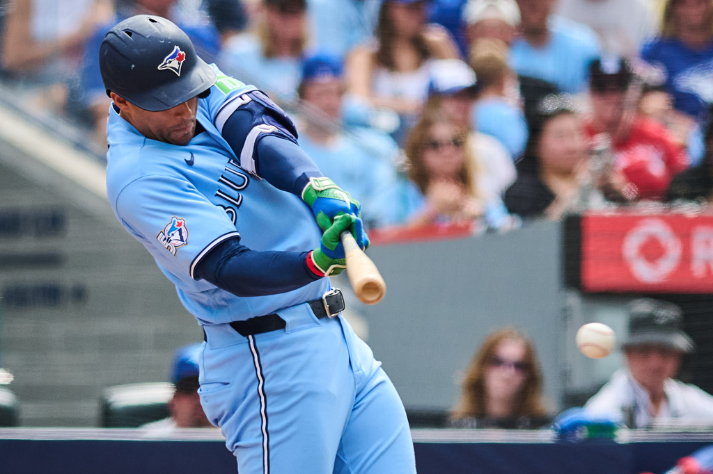 Toronto Blue Jays' George Springer hits an RBI single against the St. Louis Cardinals during the third inning of a baseball game in Toronto, Saturday, Aug. 1, 2026. (Sammy Kogan/The Canadian Press via AP)