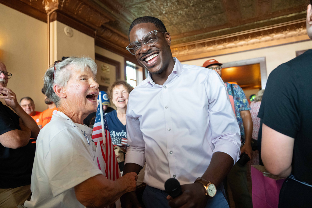 David Crowley, Democratic candidate for Wisconsin governor, shakes hands with Karen Hilt, left, during a campaign stop Friday, Aug. 7, 2026, in Sheboygan, Wis. (AP Photo/Kayla Wolf)