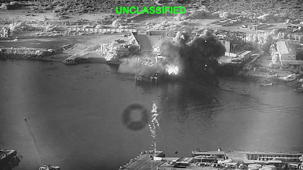 This image from video released by U.S. Central Command, shows an explosion at Bandar Abbas Naval Base, Iran, as three Corsair unmanned surface vessels, also called one-way attack surface drones, fired by the U.S. military, hit the port July 12, 2026. (U.S. Central Command via AP)