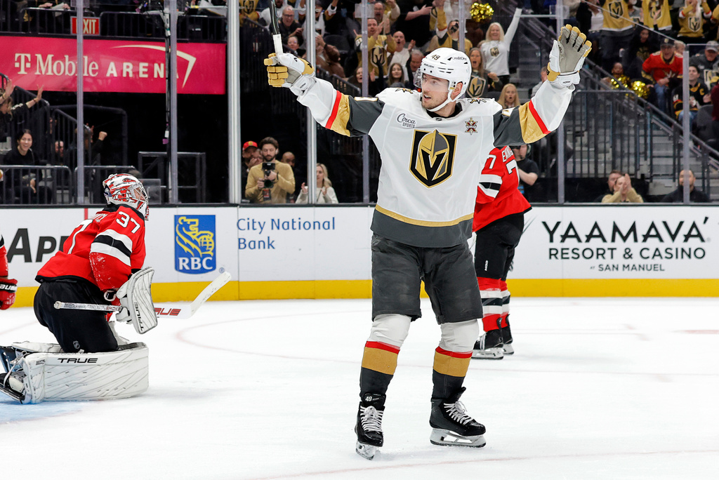 Vegas Golden Knights left wing Ivan Barbashev (49) celebrates after scoring past New Jersey Devils goaltender Connor Hellebuyck (37) during the first period of an NHL hockey game Friday, Oct. 30, 2026, in Las Vegas. (Steve Marcus/Las Vegas Sun via AP)