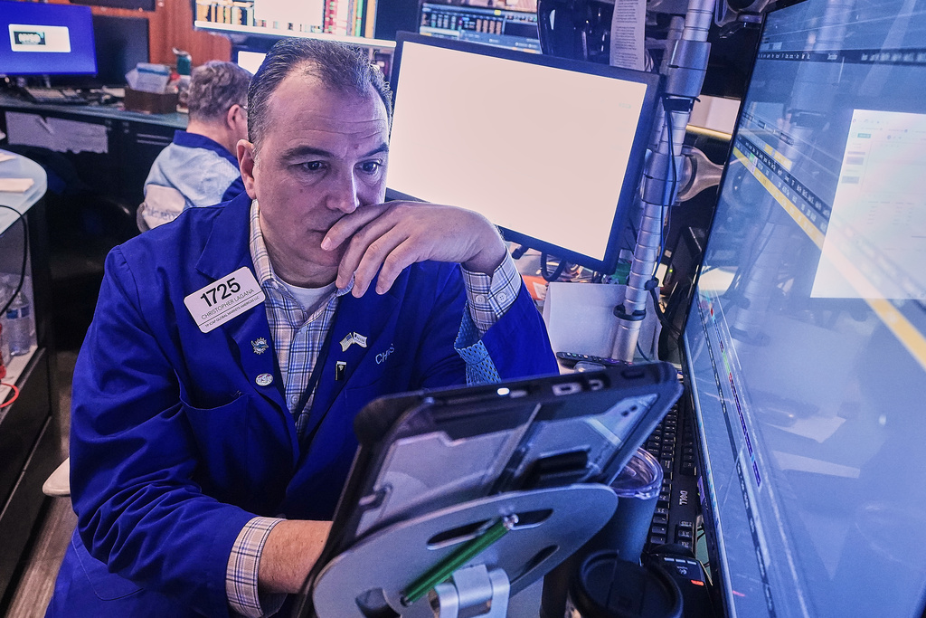 Trader Chris Lagana works on the floor of the New York Stock Exchange, Tuesday, Jan. 20, 2026. (AP Photo/Richard Drew)