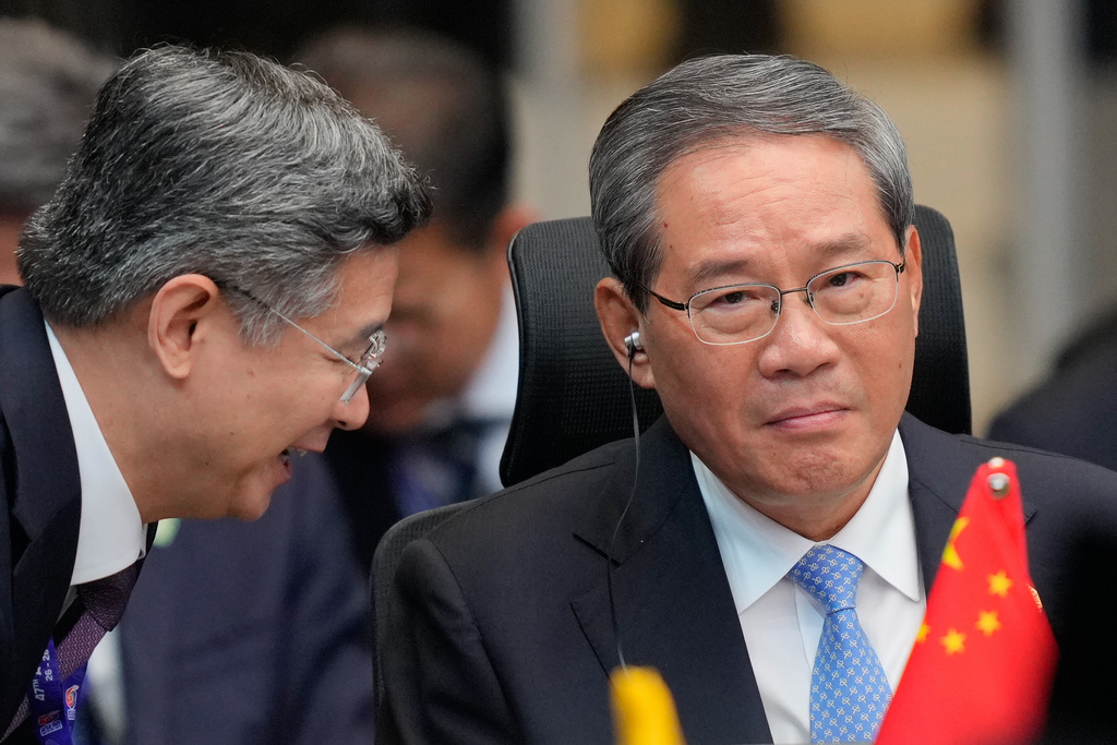 China's Premier Li Qiang, right, listens to his aide before start of the 28th ASEAN Plus Three Summit in Kuala Lumpur, Malaysia, Monday, Oct. 27, 2025. (AP Photo/Vincent Thian, Pool)
