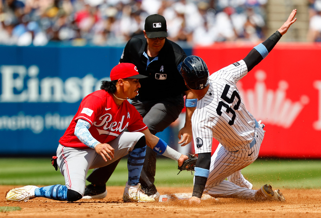 New York Yankees' Cody Bellinger (35) steals second base against Cincinnati Reds' Edwin Arroyo, left, during the third inning of a baseball game, Sunday, June 21, 2026, in New York. (AP Photo/Noah K. Murray)