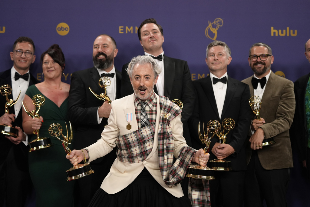 FILE - Alan Cumming, center, and the team from "The Traitors" pose in the press room with the award for outstanding reality competition program during the 76th Primetime Emmy Awards, Sept. 15, 2024, at the Peacock Theater in Los Angeles. (AP Photo/Jae C. Hong, File)