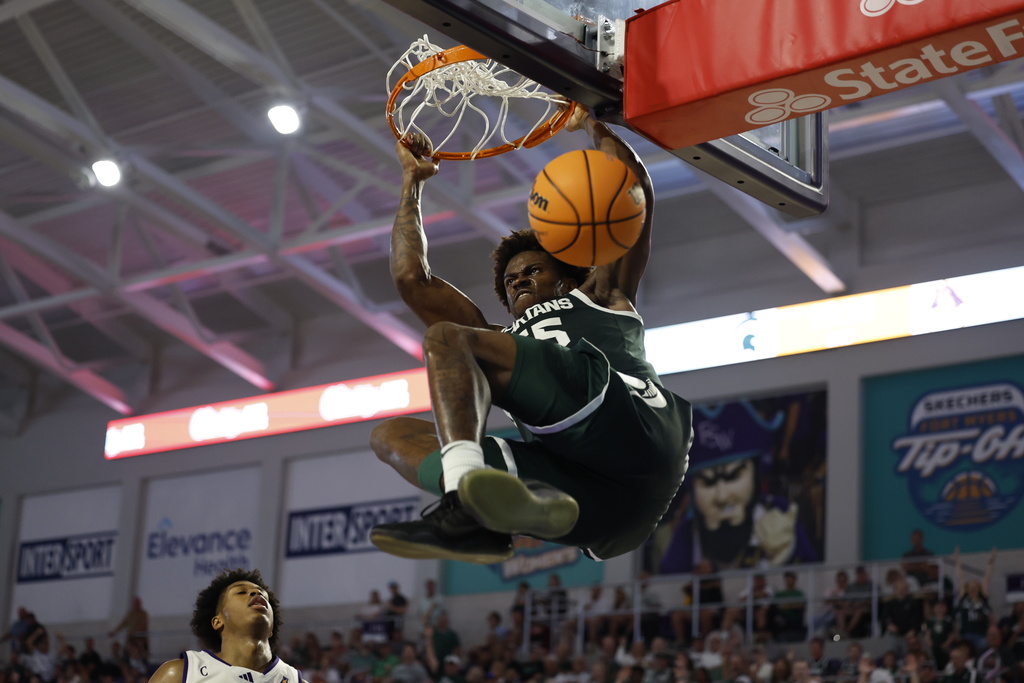 CORRECTS ID - Michigan State center Coen Carr, No. 55 dunks the ball against East Carolina during the second half of an NCAA college basketball game, Tuesday, Nov. 25, 2025 in Ft. Myers, Fla. (AP Photo/Scott Audette)