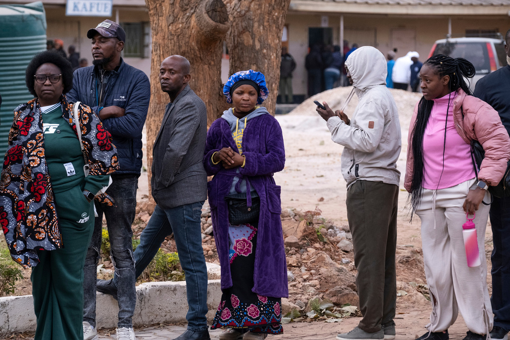 People queue up outside a polling station during a presidential election in Lusaka, Zambia, Thursday, Aug. 13, 2026. (AP Photo/Anita Reed)