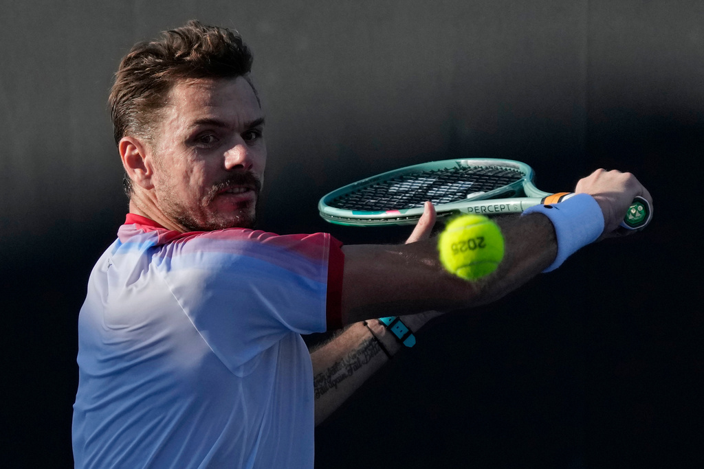FILE - Stan Wawrinka, of Switzerland, plays a backhand return to Lorenzo Sonego, of Italy, during a first-round match at the Australian Open tennis championship in Melbourne, Australia, Jan. 14, 2025. (AP Photo/Manish Swarup, File)