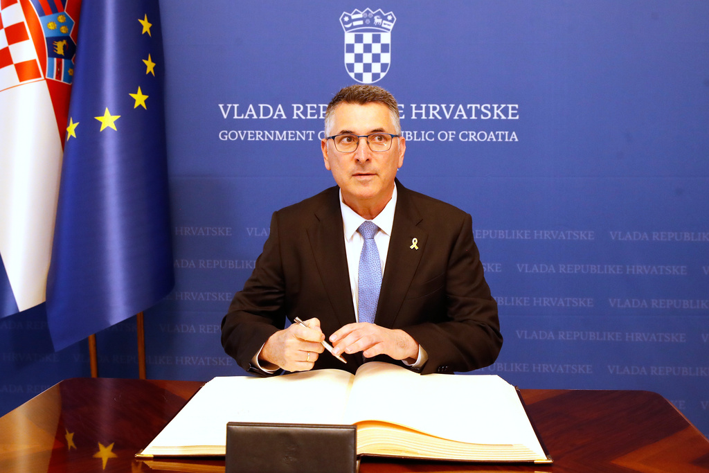 Israels's Foreign Minister Gideon Saar signs a visitors book at the government site in Zagreb, Croatia, Tuesday, Sept. 9, 2025. (AP Photo)