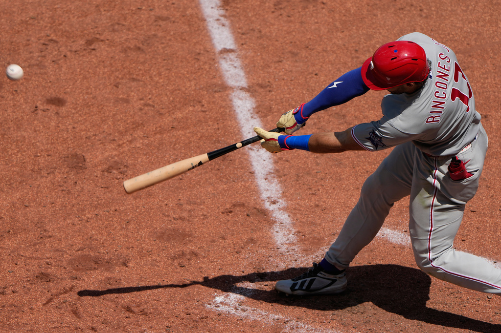 Philadelphia Phillies' Gabriel Rincones Jr. hits a sacrifice fly to score a run during the fifth inning of a baseball game against the Kansas City Royals, Sunday, July 5, 2026, in Kansas City, Mo. (AP Photo/Charlie Riedel)
