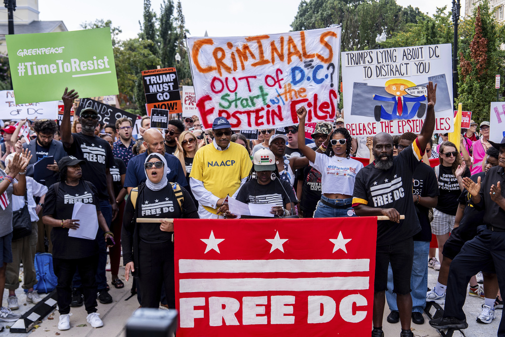 Protesters demonstrate against President Donald Trump's planned use of federal law enforcement and National Guard troops in Washington, during a rally in front of the White House, Monday, Aug. 11, 2025, in Washington. (AP Photo/Julia Demaree Nikhinson)