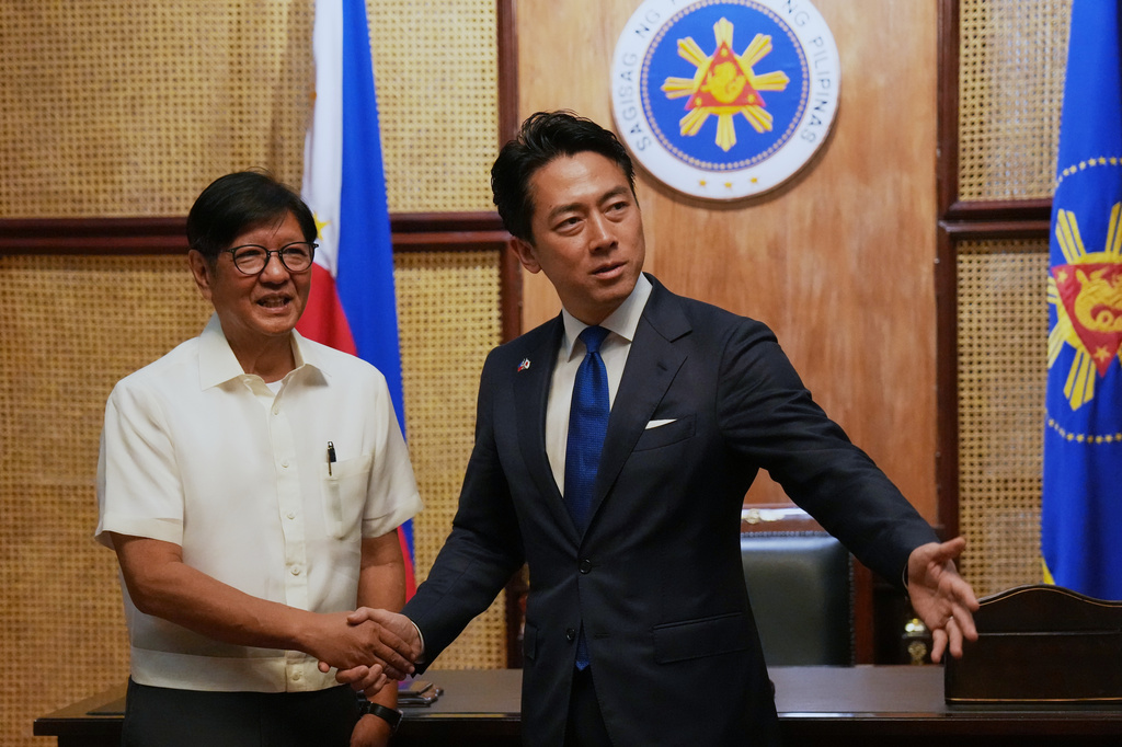 Philippine President Ferdinand Marcos Jr., left, greets Japan's Defense Minister Shinjiro Koizumi at the Malacanang presidential palace in Manila, Philippines on Tuesday, May 5, 2026. (AP Photo/Aaron Favila, Pool)