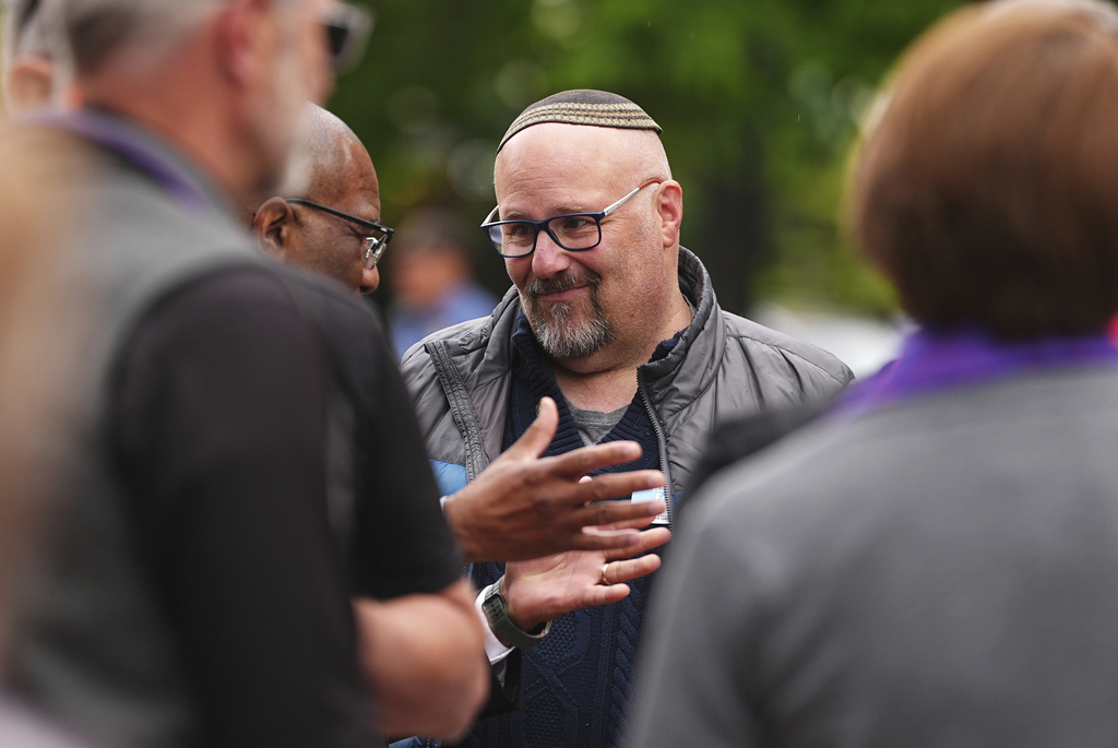FILE - Rabbi Fred Greene of Congregation Har HaShem in Boulder, Colo., talks with fellow celebrants of a tribute at a makeshift memorial for victims of an attack outside of the Boulder County, Colo., courthouse Tuesday, June 3, 2025, in Boulder, Colo. (AP Photo/David Zalubowski, File)