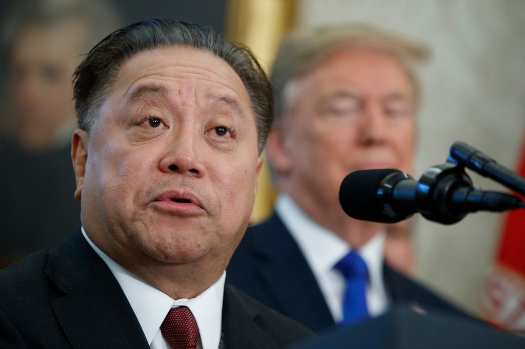 FILE - In this Nov. 2, 2017, file photo, Broadcom CEO Hock Tan speaks as President Donald Trump listens during an event to announce the company is moving its global headquarters to the United States, in the Oval Office of the White House, in Washington. (AP Photo/Evan Vucci, File)