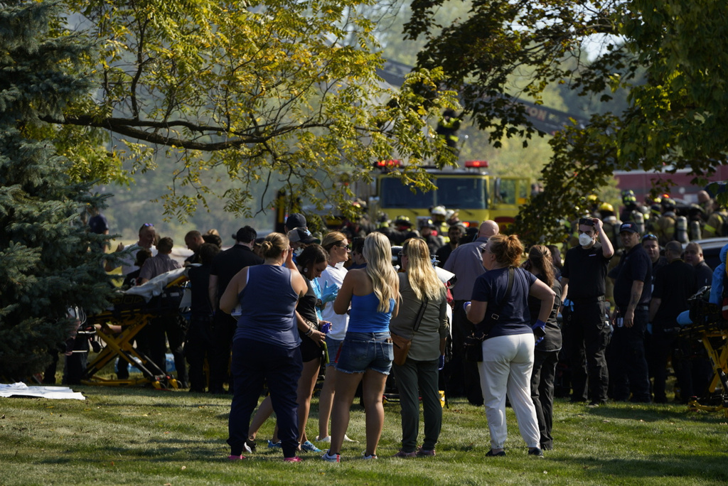 Emergency responders work the scene outside The Church of Jesus Christ of Latter-day Saints following a shooting and fire in Grand Blanc, Mich., Sunday, Sept. 28, 2025. (Lukas Katilius/The Flint Journal via AP)