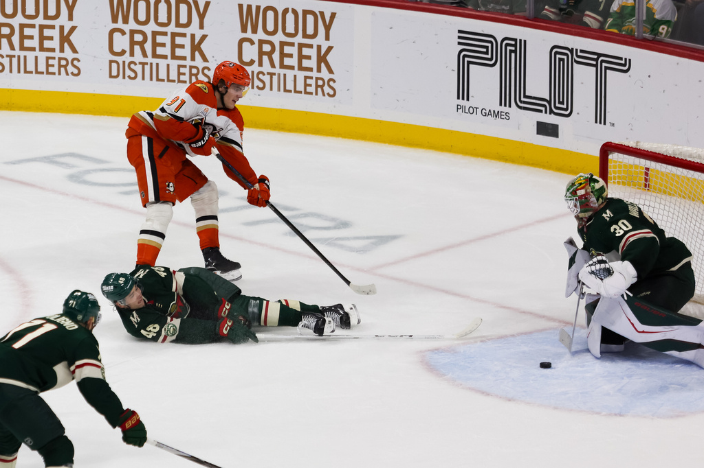 Anaheim Ducks' Leo Carlsson (91) attempts a goal while Minnesota Wild's Daemon Hunt (48) and Jesper Wallstedt (30) block the net during the second period of an NHL hockey game Tuesday, April 14, 2026, in St. Paul, Minn. (AP Photo/Lily Dozier)