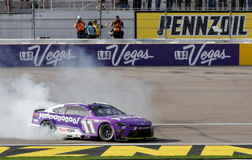 Denny Hamlin (11) performs a burnout after winning a NASCAR Cup Series auto race at Las Vegas Motor Speedway, Sunday, March 15, 2026, in Las Vegas. (AP Photo/Steve Marcus)