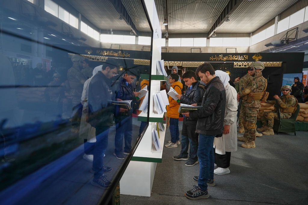Visitors browse through books at a stand operated by the Syrian Defense Ministry during the 57th Damascus International Book Fair in Damascus, Syria, Monday, Feb. 16, 2026, the first edition since the collapse of the Assad regime. (AP Photo/Omar Sanadiki)