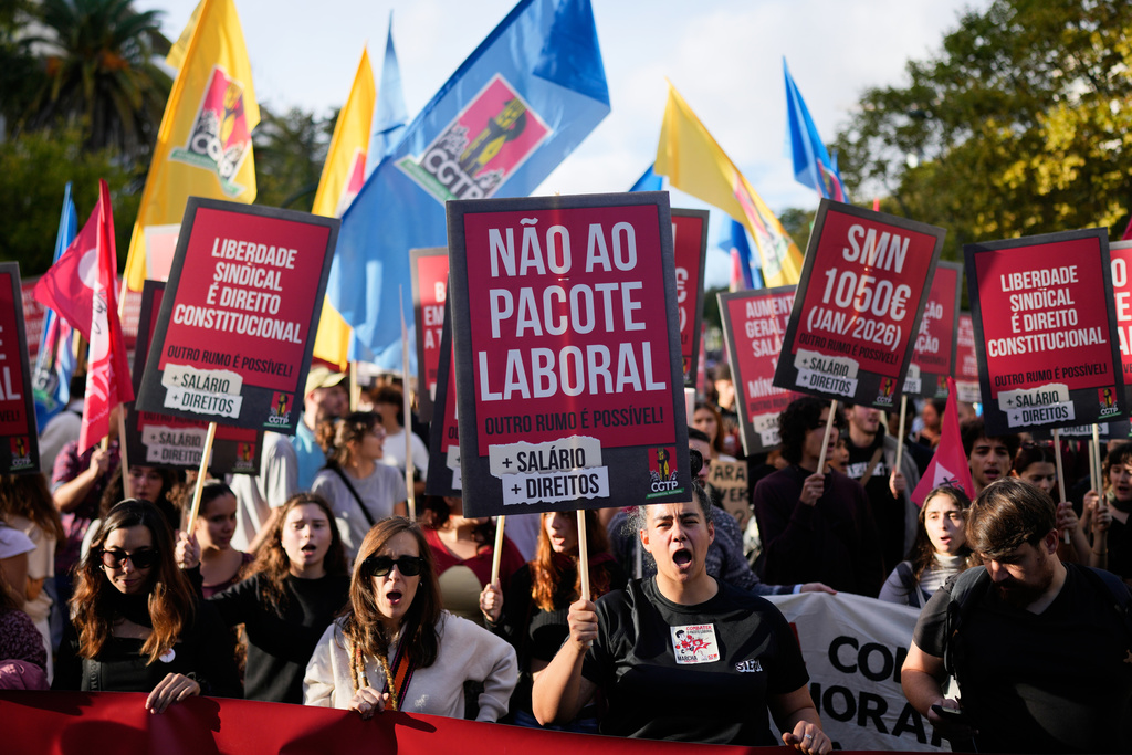A demonstrator carrying a poster with the words "No to the labour package" shouts slogans during a national protest by workers unions against a new labour package being prepared by the government, in Lisbon, Saturday, Nov. 8, 2025. (AP Photo/Armando Franca)