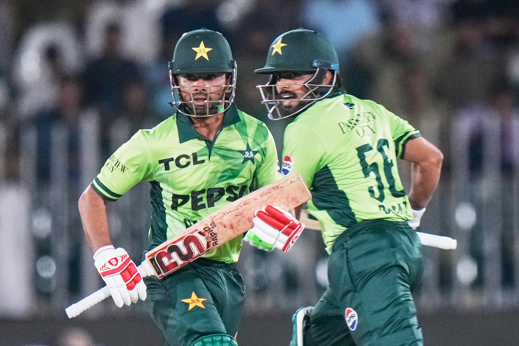 Pakistan's Ghazi Ghori, left, and Babar Azam run between the wickets to score during the first one day international cricket match between Pakistan and Australia, in Rawalpindi, Pakistan, Saturday, May 30, 2026. (AP Photo/Anjum Naveed)