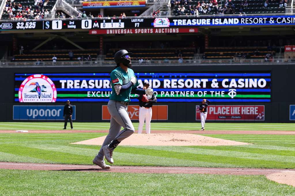 Seattle Mariners J.P. Crawford trots home after hitting a home run during the third inning of a baseball game against the Minnesota Twins, Wednesday, April 29, 2026, in Minneapolis. (AP Photo/Stacy Bengs)