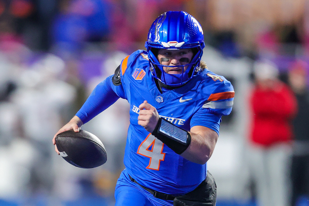 FILE - Boise State quarterback Maddux Madsen (4) scrambles with the ball on a touchdown run against UNLV in the first half of the Mountain West championship NCAA college football game, Dec. 5, 2025, in Boise, Idaho. (AP Photo/Steve Conner, File)