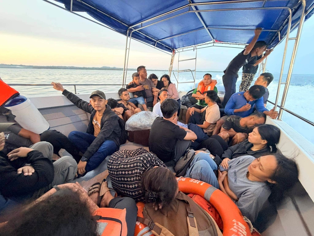 Rescued passengers from M/V Trisha Kerstin, 3 an inter-island cargo and passenger ferry that sank, on a boat around waters of Isabela City, Basilan Province, Philippines on Monday, Jan. 26, 2026. (Kagawad Gamar "Gams" Alih via AP)