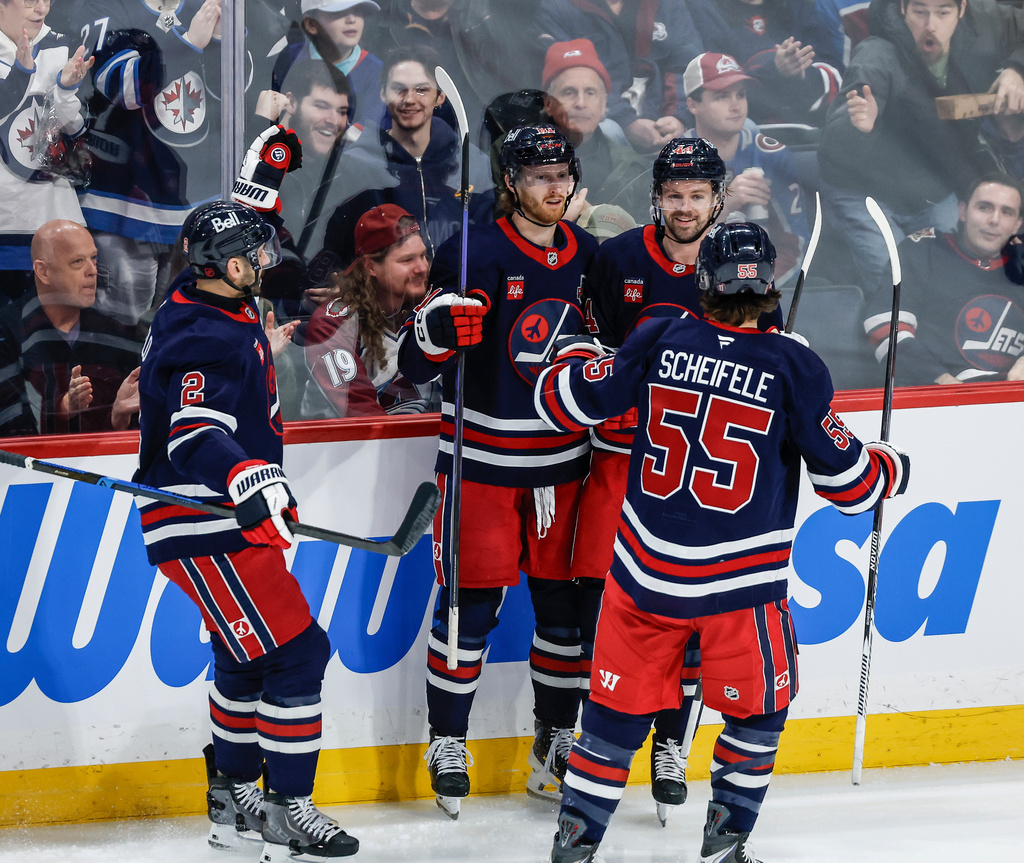 Winnipeg Jets players celebrate Kyle Connor's (81) goal against the Colorado Avalanche during the second period of an NHL game in Winnipeg, Saturday, March 14, 2026. (John Woods/The Canadian Press via AP)