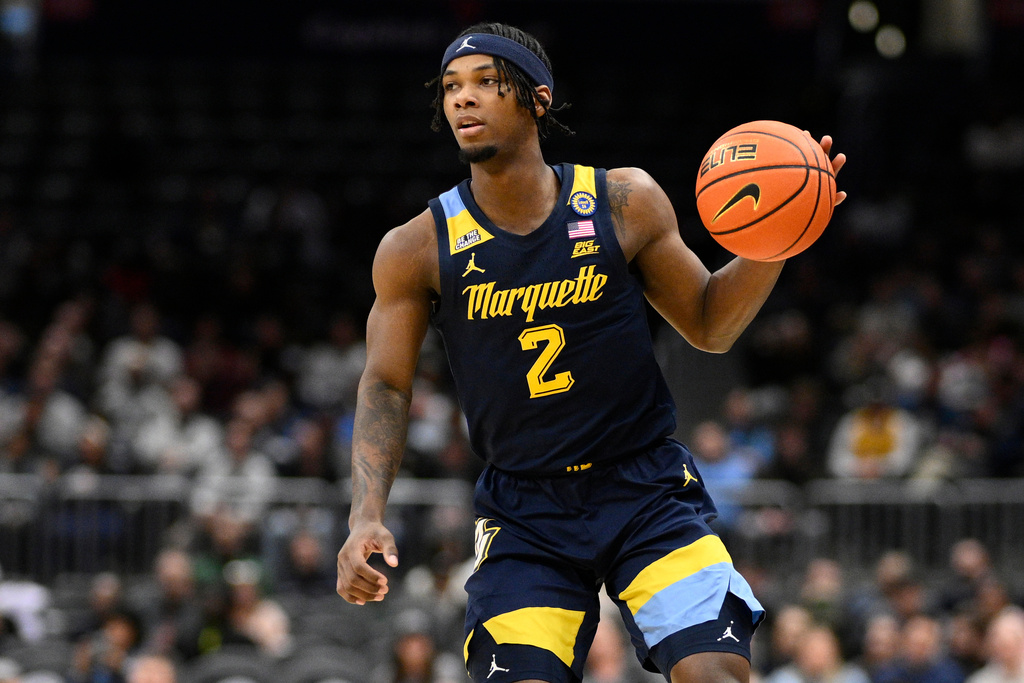 FILE - Marquette guard Chase Ross (2) dribbles during the second half of an NCAA college basketball game against Georgetown, Saturday, March 1, 2025, in Washington. (AP Photo/Nick Wass, File)