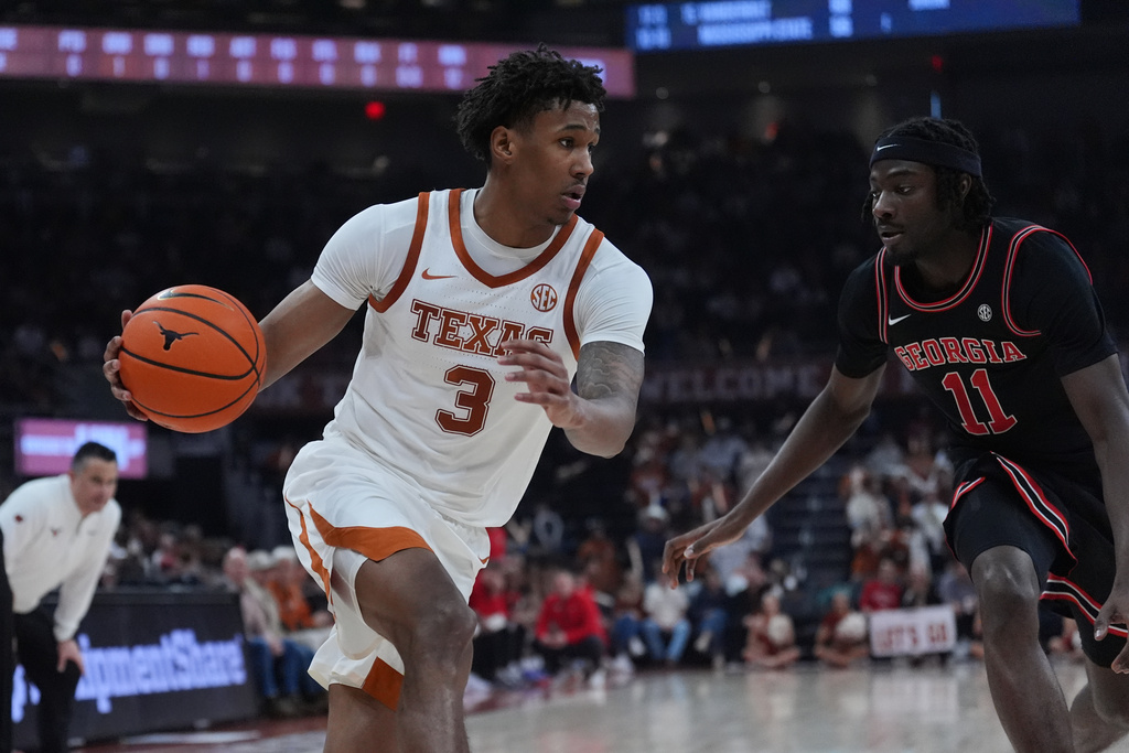 Texas guard Dailyn Swain (3) drives against Georgia forward Dylan James (11) during the second half of an NCAA college basketball game in Austin, Texas, Saturday, Jan. 24, 2026. (AP Photo/Eric Gay)